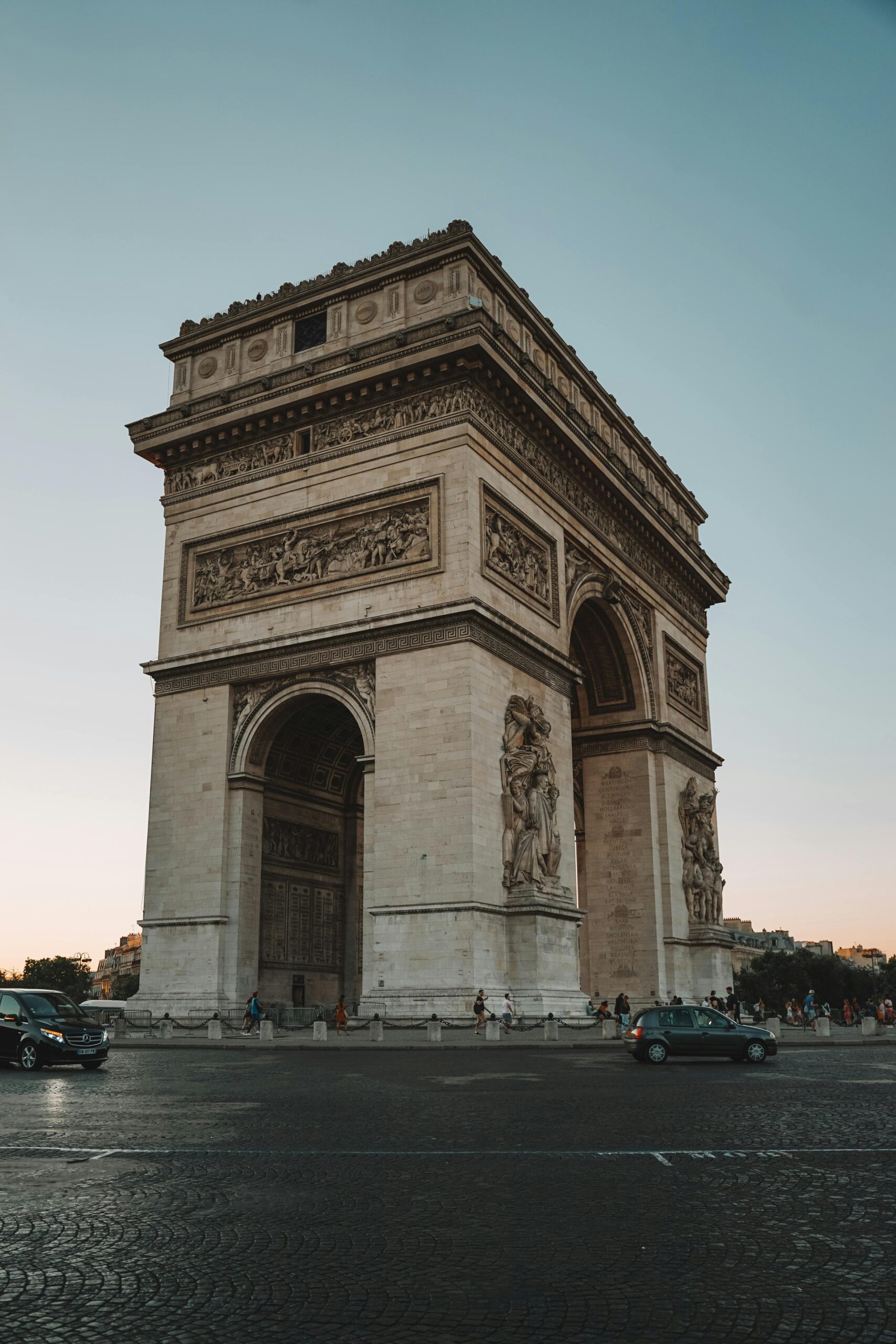 A stunning view of the Arc de Triomphe in Paris captured during the golden hour, highlighting its architectural beauty.