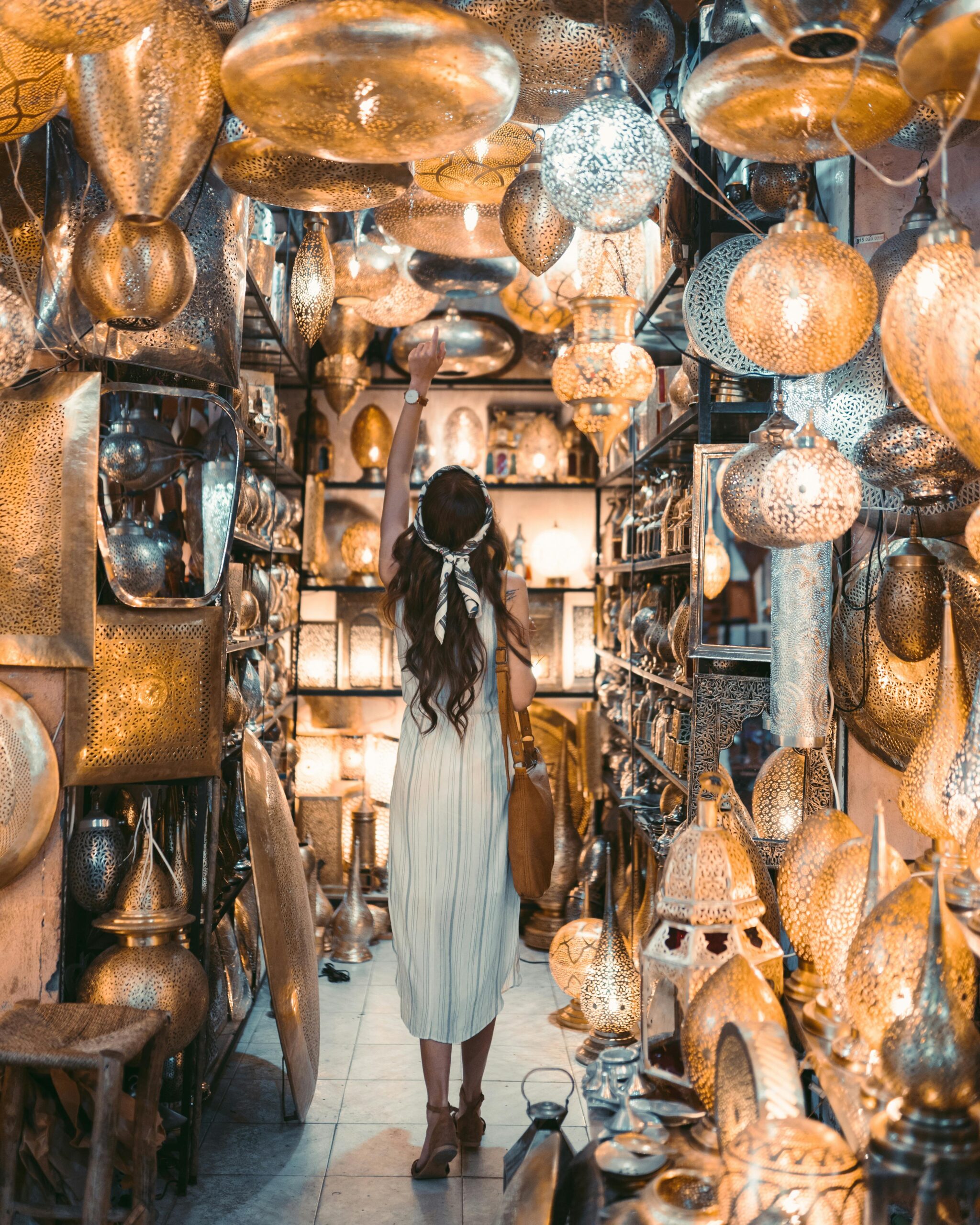 Explore a vibrant lantern shop filled with warm glow and intricate designs in Marrakesh.